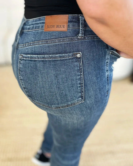 Judy Blue Full Size Mid Waist Distressed Slim Jeans - Trendsi